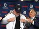 Al Avila, right, helps Ron Gardenhire get into a Tiger